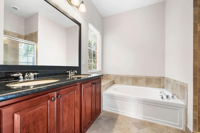 bathroom with plus walk in shower, vanity, and tile patterned floors