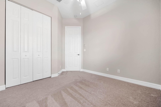 unfurnished bedroom featuring carpet flooring, a closet, and ceiling fan