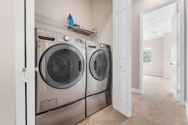 clothes washing area with washing machine and clothes dryer