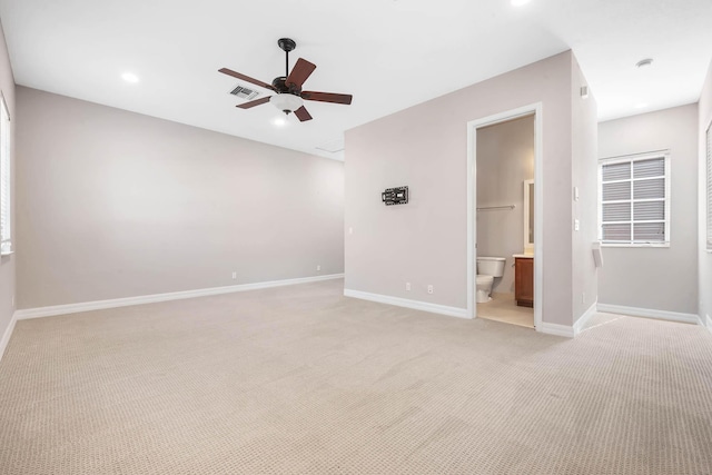 spare room with light carpet and ceiling fan