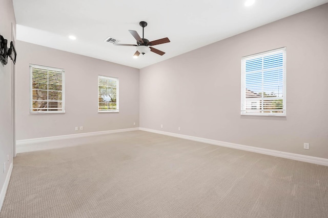 carpeted spare room with ceiling fan