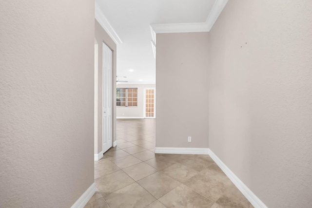 corridor with crown molding and light tile patterned flooring