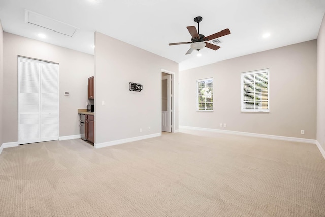 carpeted spare room featuring ceiling fan