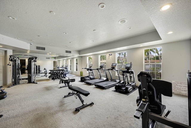 gym featuring carpet flooring and a textured ceiling