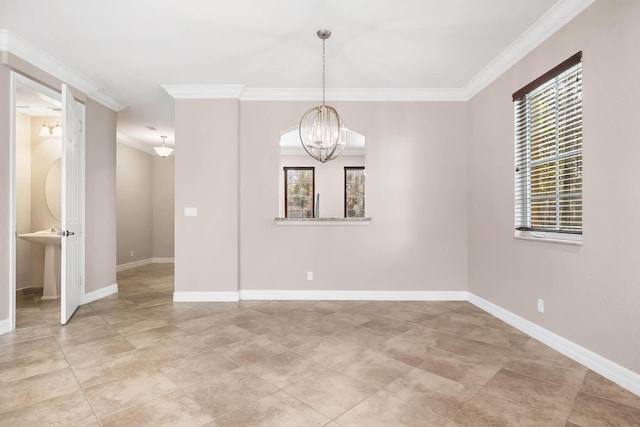 empty room featuring crown molding and a chandelier