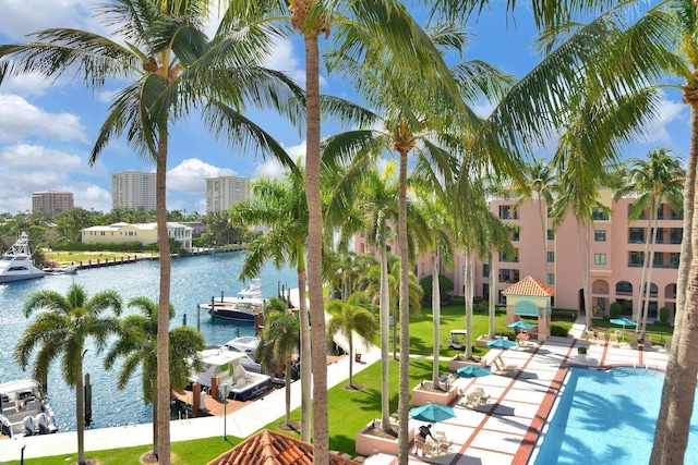 view of swimming pool featuring a dock and a water view