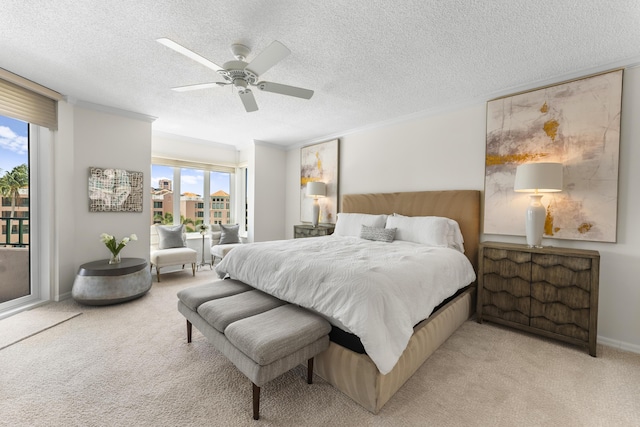 bedroom with access to outside, multiple windows, ceiling fan, and a textured ceiling