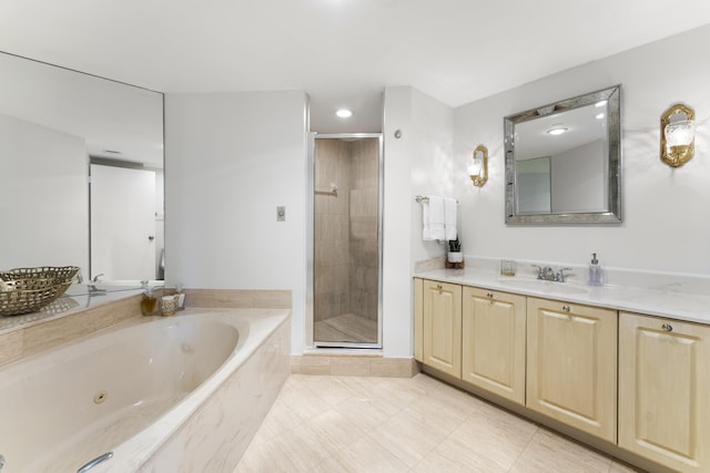 bathroom with tile patterned floors, vanity, and shower with separate bathtub