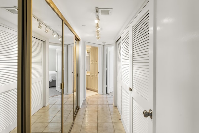 hallway featuring light tile patterned floors