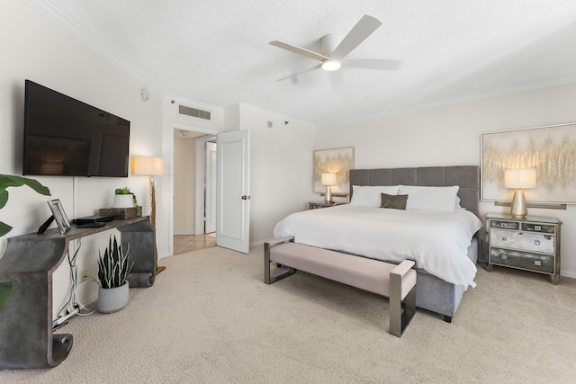 carpeted bedroom with ceiling fan, ornamental molding, and a textured ceiling