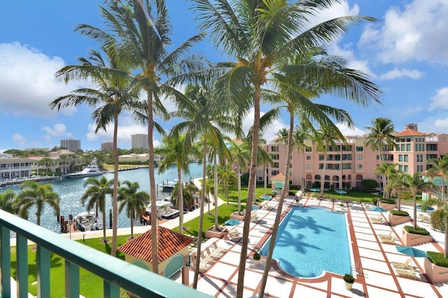 view of pool with a patio area and a water view