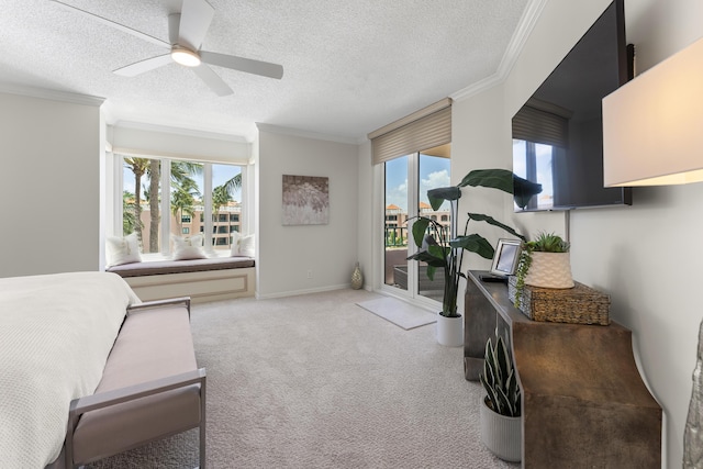 carpeted bedroom with access to exterior, a textured ceiling, multiple windows, and ceiling fan