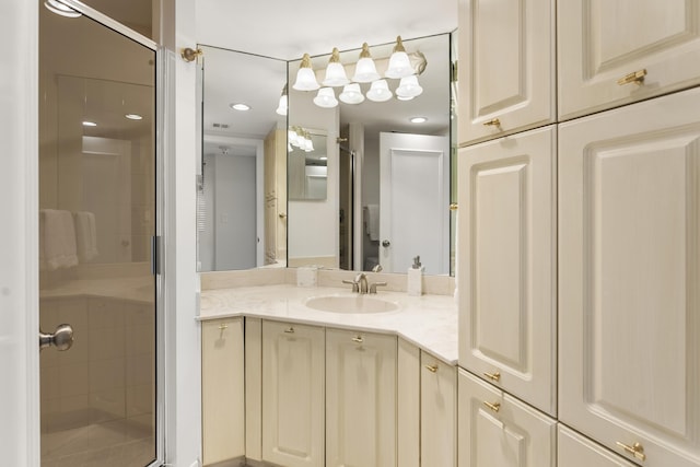 bathroom with vanity and a shower with door