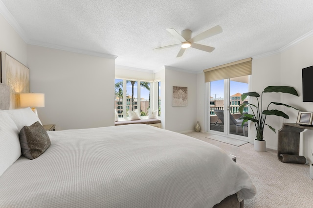 bedroom with ceiling fan, crown molding, light colored carpet, and a textured ceiling