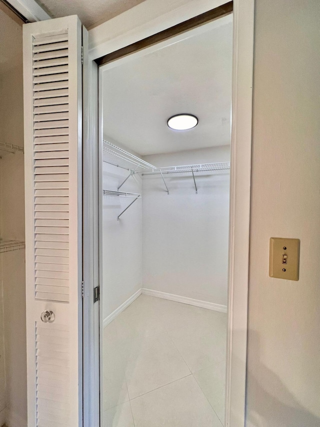 walk in closet featuring light tile patterned floors