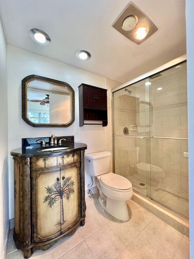 bathroom featuring walk in shower, tile patterned floors, vanity, and toilet