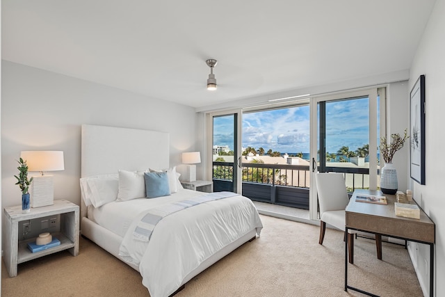 bedroom with access to outside, ceiling fan, and light colored carpet