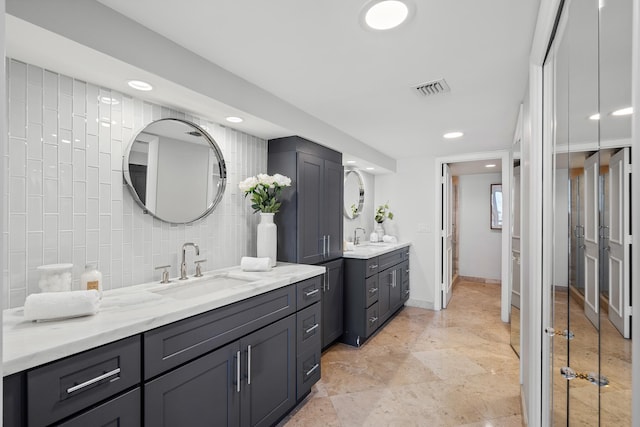 bathroom with decorative backsplash and vanity