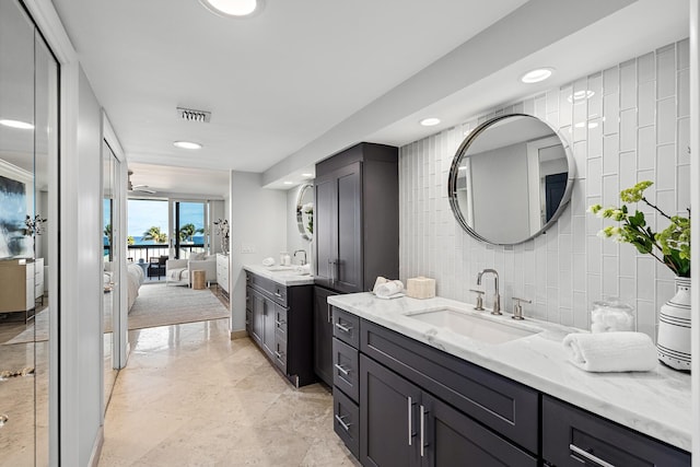 bathroom featuring vanity, backsplash, and tile walls