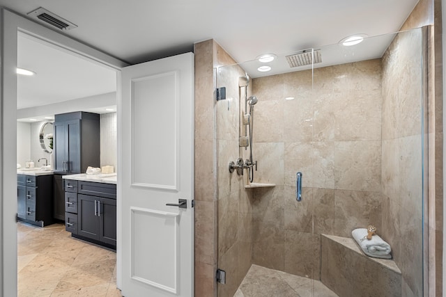 bathroom with vanity and a shower with door