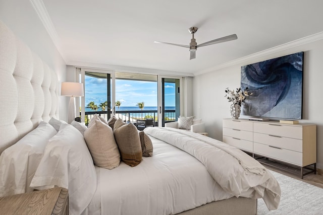 bedroom with access to exterior, ceiling fan, expansive windows, crown molding, and a water view