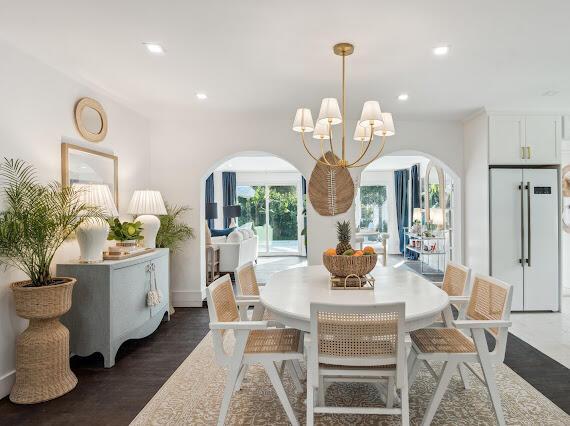 dining space featuring dark hardwood / wood-style floors and a chandelier