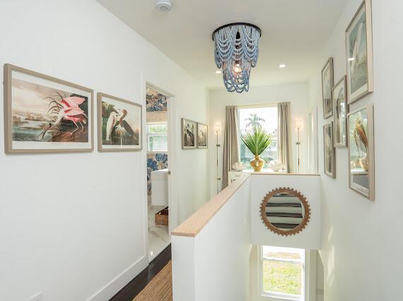 hallway featuring an inviting chandelier and dark hardwood / wood-style flooring