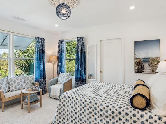 bedroom featuring light colored carpet