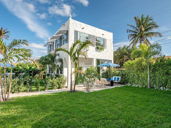 back of house featuring a patio and a yard