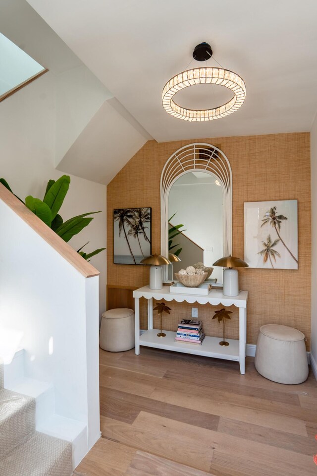 interior space featuring vaulted ceiling and light hardwood / wood-style floors