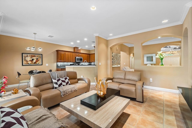 living room featuring crown molding, light tile patterned floors, and a notable chandelier