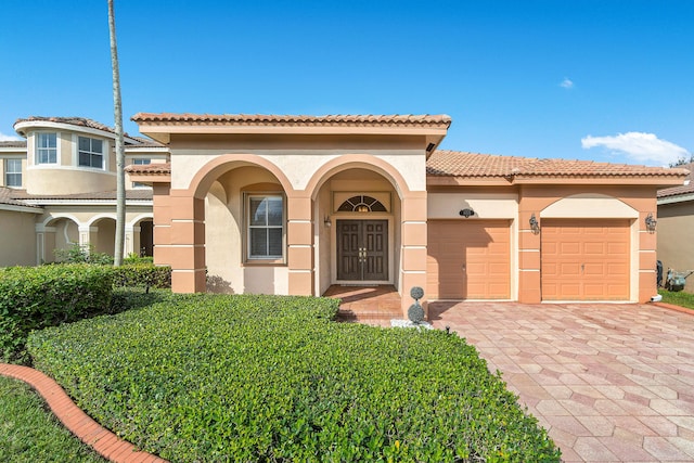 mediterranean / spanish home with a garage