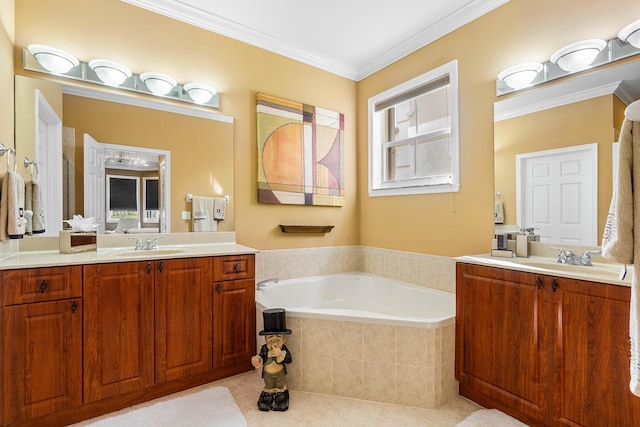 bathroom featuring tiled tub, crown molding, tile patterned flooring, and vanity