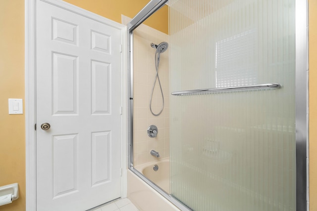 bathroom featuring tile patterned floors and combined bath / shower with glass door