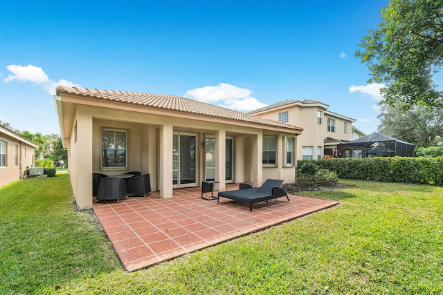 back of house featuring a patio area and a yard