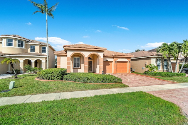 mediterranean / spanish home with a front yard and a garage