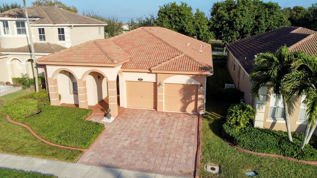 mediterranean / spanish-style home with a garage