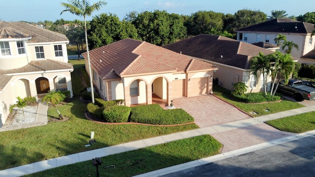 mediterranean / spanish-style house featuring a front yard