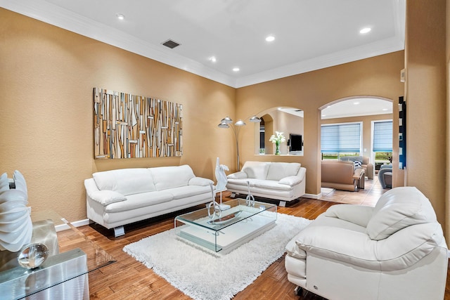 living room with hardwood / wood-style flooring and crown molding