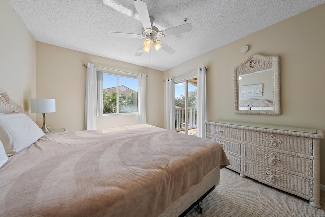 carpeted bedroom featuring ceiling fan, a textured ceiling, and access to outside