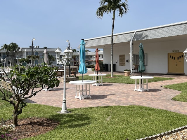 view of home's community featuring a yard and a patio area