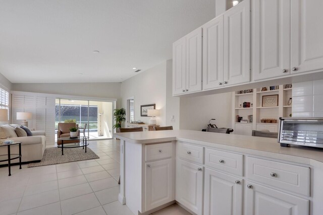 kitchen featuring decorative backsplash, dishwasher, white cabinets, and sink