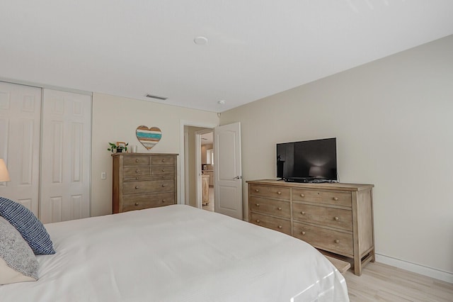 bedroom featuring a closet and light wood-type flooring