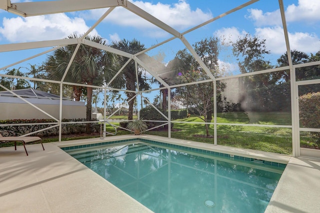 view of swimming pool featuring a lanai and a patio area