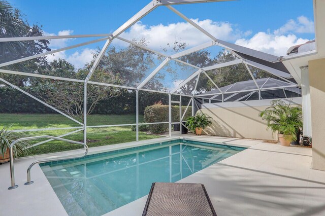 view of pool featuring a patio and glass enclosure