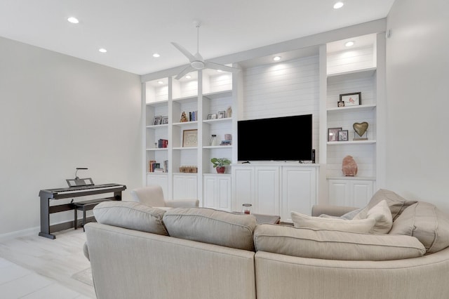 living room with light wood-type flooring, built in features, and ceiling fan