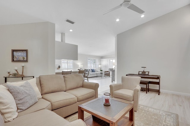 living room featuring ceiling fan and vaulted ceiling