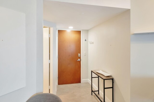 workout area featuring a paneled ceiling, a water view, and a beach view