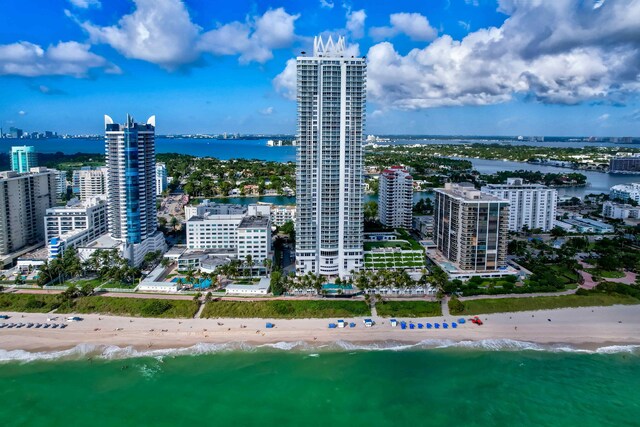 birds eye view of property featuring a view of the beach and a water view