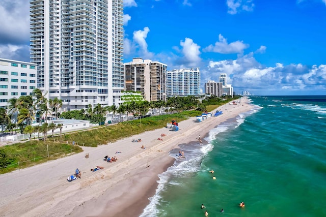 bird's eye view with a water view and a beach view